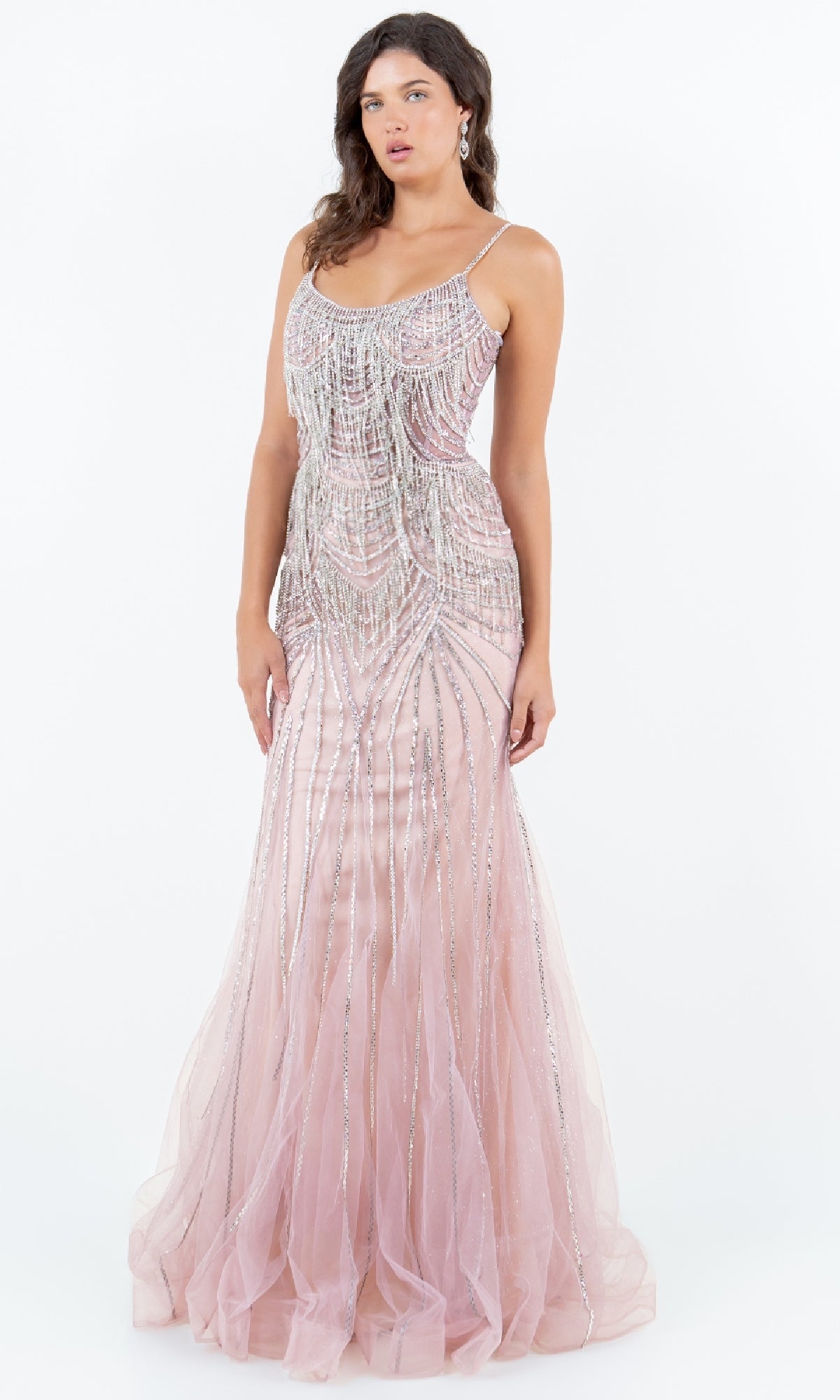 A woman wears the Beaded Long Prom Dress: Cinderella Couture 8192J—a floor-length, blush pink, lace-up gown with silver beads—standing against a plain white background.